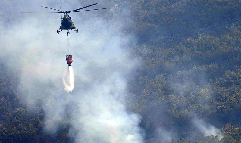 A Macedonian Army helicopter extinguishes a forest fire near the village of Kopance 25 km.